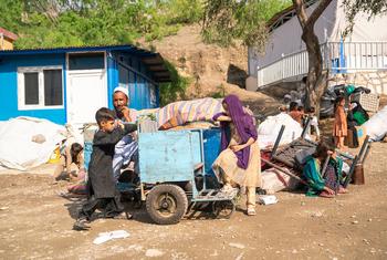 A family sit beside their belongings after crossing into Afghanistan from Pakistan.