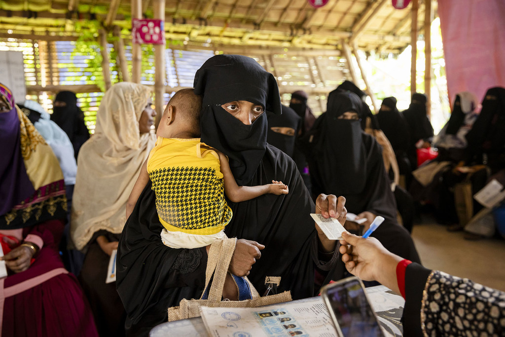 A woman collects monthly a food ration voucher food in a Rohingya refugee camp in Cox’s Bazar, Bangladesh. (file)