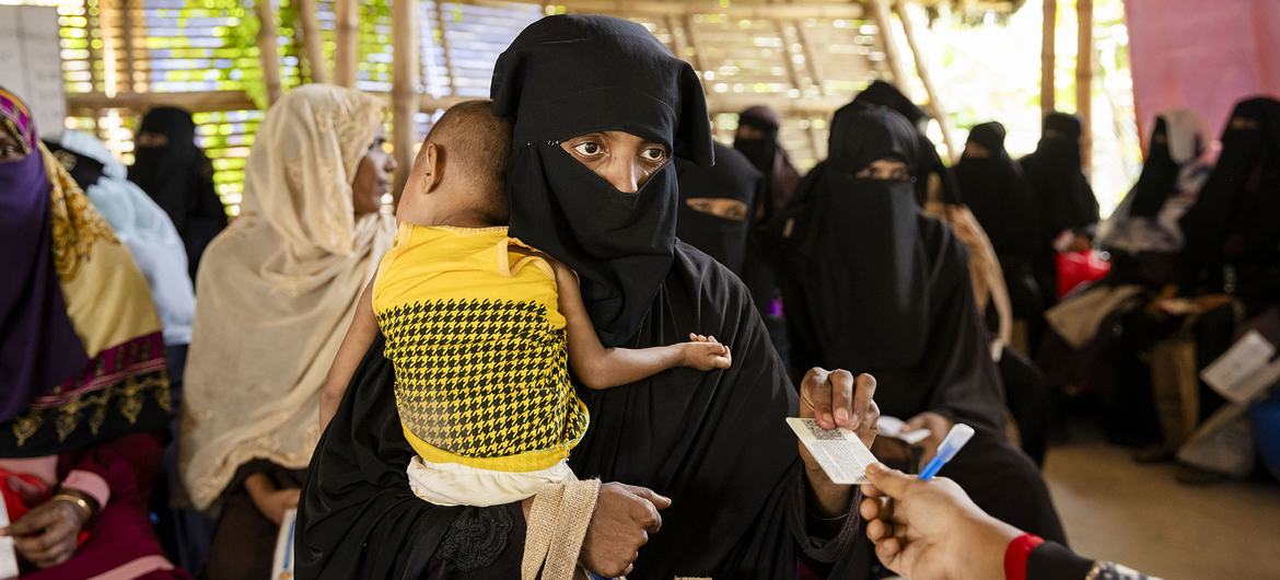 A woman collects monthly a food ration voucher food in a Rohingya refugee camp in Cox’s Bazar, Bangladesh. (file)