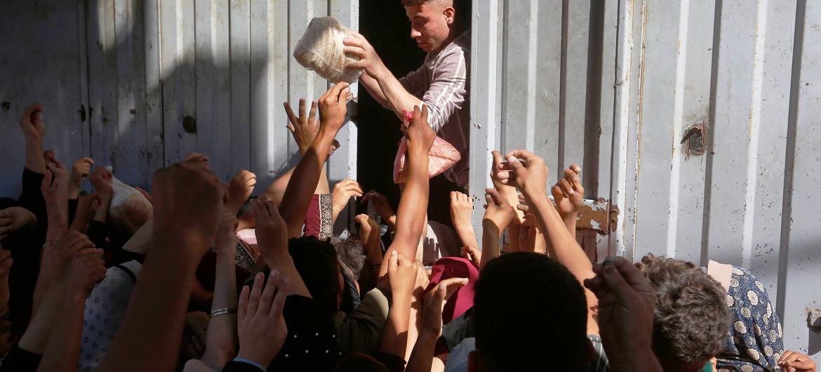 Bread is handed out to people in Deir Al-Balah in the central part of the Gaza Strip.