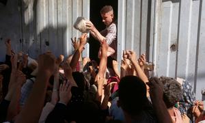 Bread is handed out to people in Deir Al-Balah in the central part of the Gaza Strip.