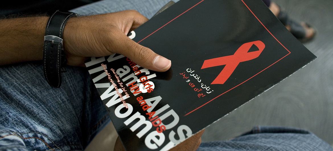 A man holds a brochure about HIV/AIDS as he waits to attend a meeting on the disease in Iran. (file) A man holds a brochure about HIV/AIDS as he waits to attend a meeting on the disease in Iran. (file)
