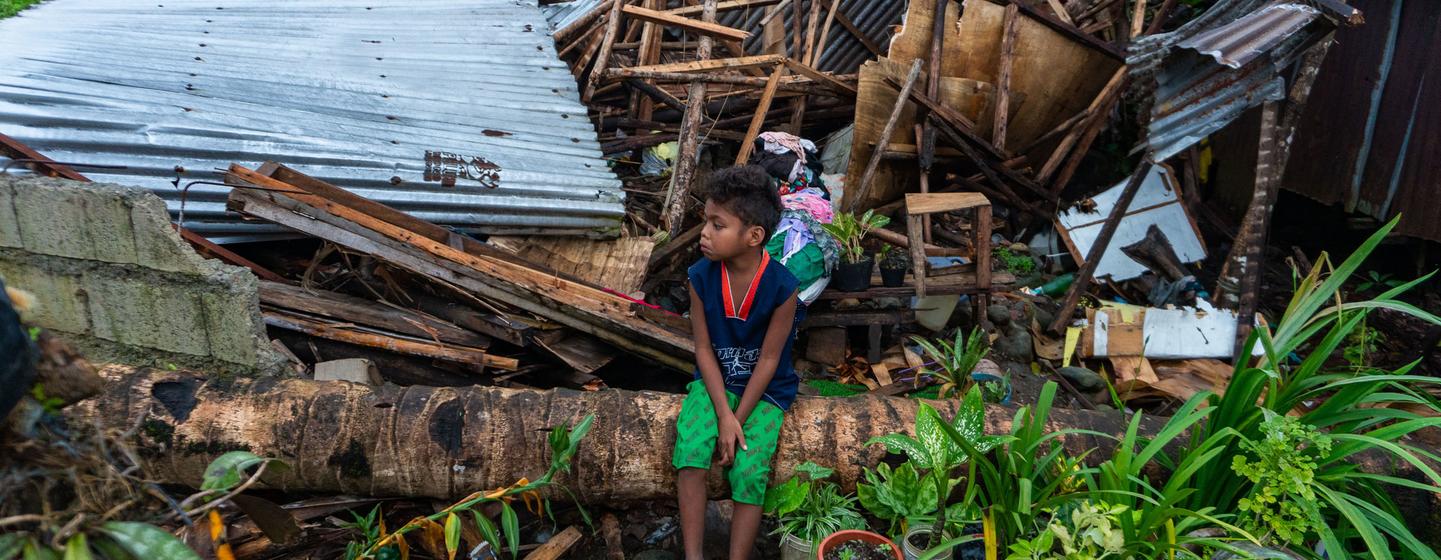 A child from the Badjao Indigenous community in the Philippines sits amid the wreckage left by a typhoon. A child from the Badjao Indigenous community in the Philippines sits amid the wreckage left by a typhoon.