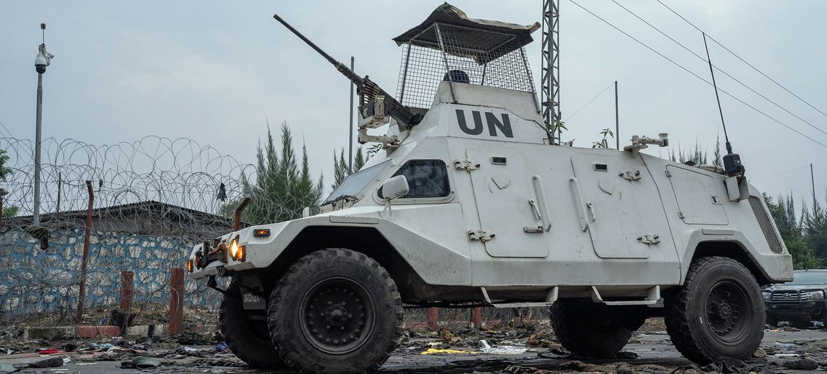 UN peacekeepers patrol in Goma past discarded military uniforms.