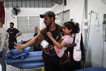 A 10-year-old girl is carried into the Al-Awda Hospital in Nuseirat camp, Gaza.