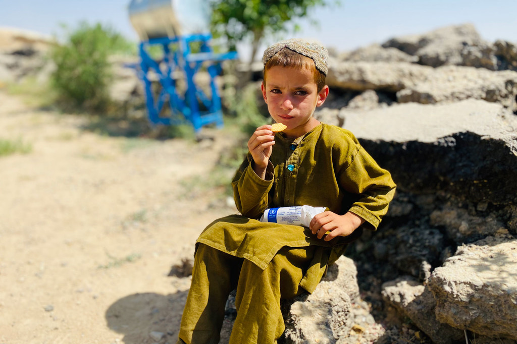 A primary school student in Zabul Province, Afghanistan, eats fortified biscuits provided by WFP (file)