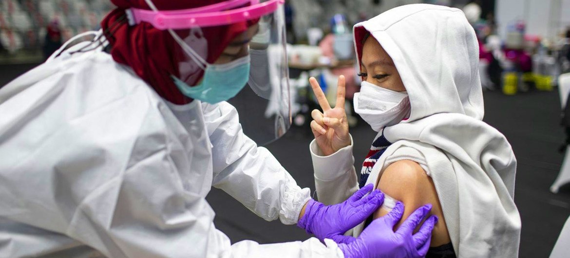 A COVID-19 vaccine is administered in Indonesia.