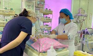 A woman checks on her newborn as a nurse monitors the baby's condition at a perinatal centre in Astana, Kazakhstan.