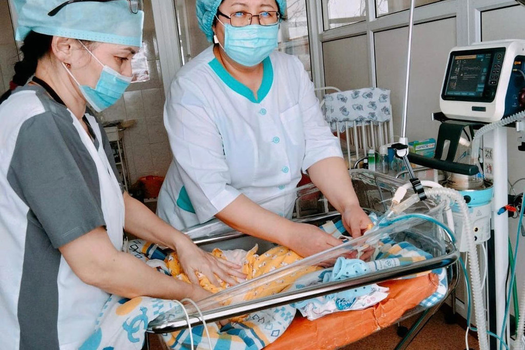 Doctors check the condition of a newborn baby  who needs medical assistance at a hospital in Kazakhstan.