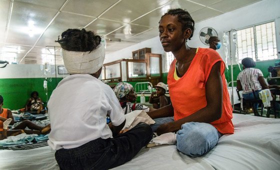 A woman attends to her four-year-old son who was injured in the Haiti earthquake in August 2021.