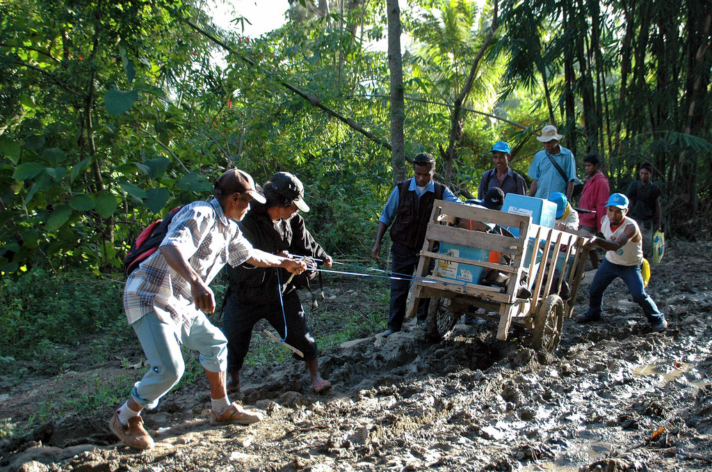 Officers of the Technical Secretariat for Electoral Administration drag a cart full of ballot boxes for distribution in remote communities of Timor-Leste, in preparation of elections in 2007. (file)