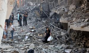 Residents survey the damage in a suburb of southern Beirut left in ruins after being targeted by airstrikes.