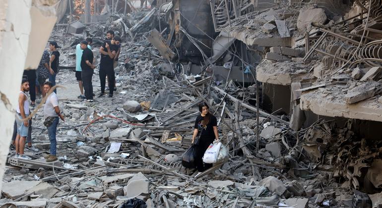 Residents survey the damage in a suburb of southern Beirut left in ruins after being targeted by airstrikes.