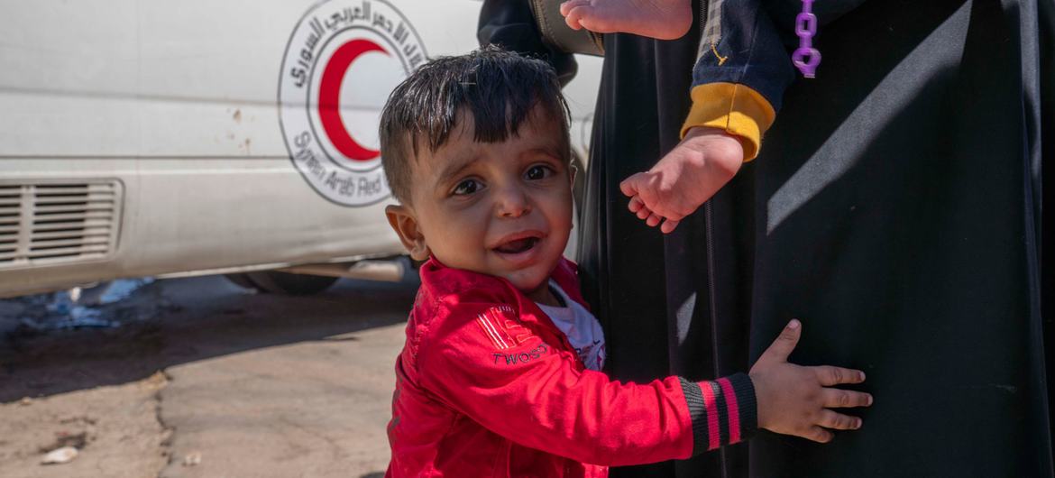 A young boy and his family arrive at the Syrian border after fleeing Beirut.