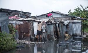 A man in Les Cayes in Haiti repairs his home which was damaged by Hurricane Melissa.