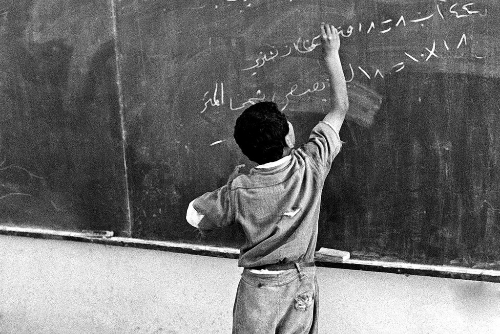 A young student solves a mathematical problem at a school in Nabatieh refugee camp. (file)