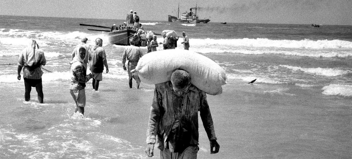 People in the Gaza Strip collect relief supplies delivered by boat in 1957. (file)