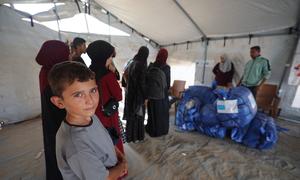 Families receive blankets in Gaza.