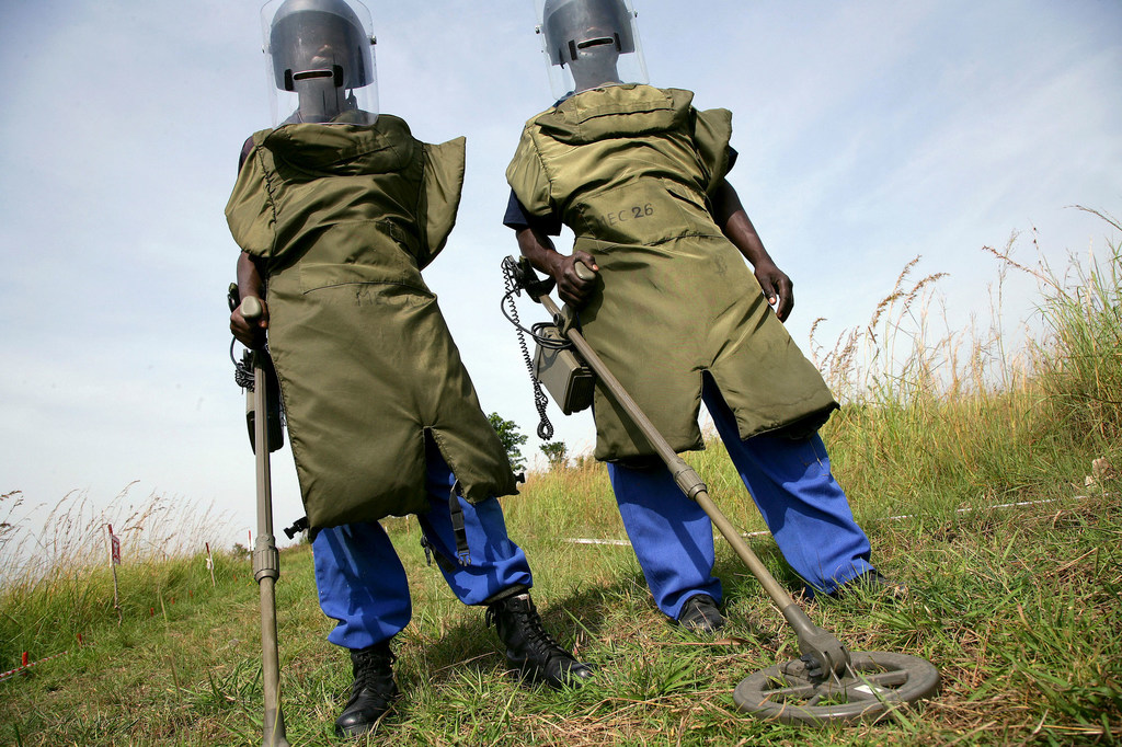 Two deminers work to decontaminate the land in Bunia, the Democratic Republic of the Congo.