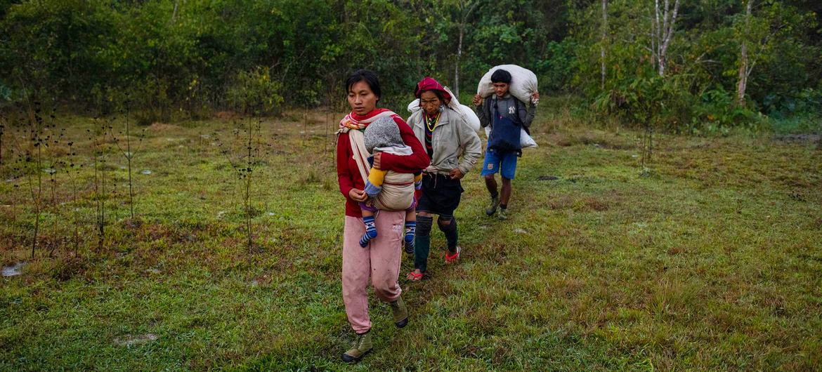 A family walks through Kayah State, in southeastern Myanmar, on their way to safety across the border to Thailand. 