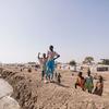 Children stand by a dike at a camp for people displaced by conflict in South Sudan. 