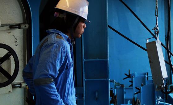 A seafarer works on a ship.