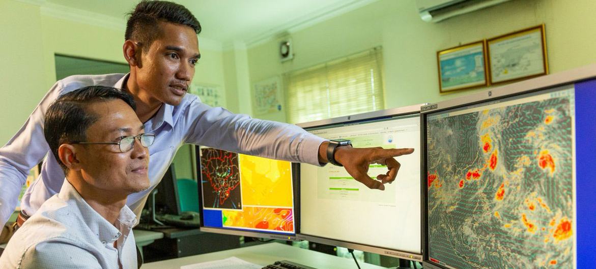 Climate forecasters in Cambodia consult data from an early warning system.