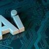 在电路板上放置3D呈现的"AI"字母,象征人工智能和技术.