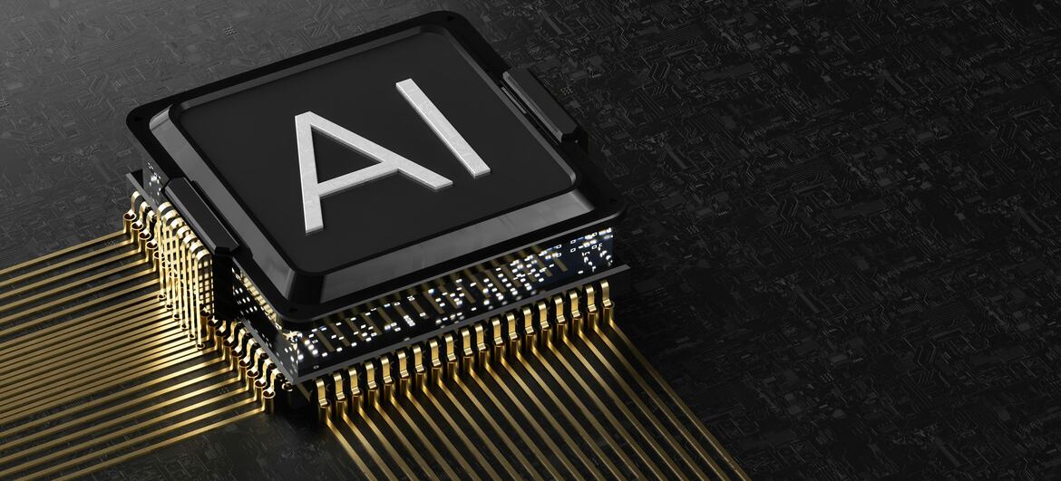A close-up of a computer chip with 'AI' printed on its surface, connected by gold pins on a dark circuit board.