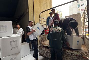 UNIFIL personnel distribute food kits to displaced families in Saida, Lebanon.