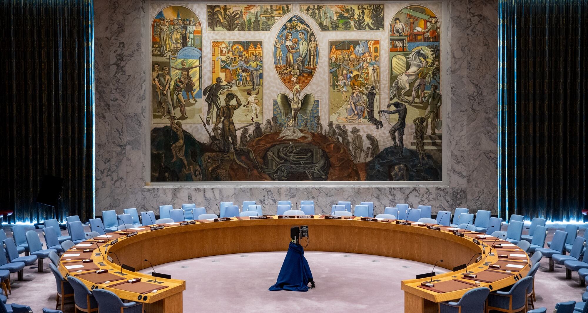 The Security Council Chamber of the United Nations, featuring a large mural by Norwegian artist Per Krohg depicting a phoenix rising from ashes of war and slavery into a peaceful world, donated in 1952.