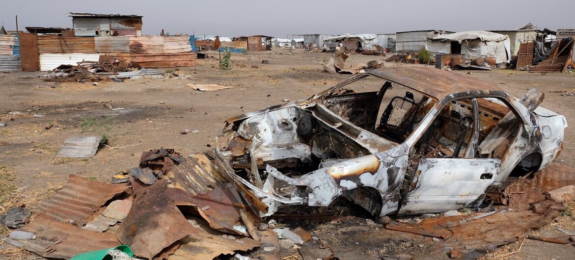 A destroyed vehicle lies in a village in South Sudan's Upper Nile region, following an outbreak of fighting that has deepened the humanitarian crisis.