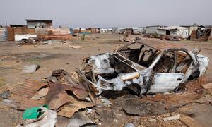 A destroyed vehicle lies in a village in South Sudan's Upper Nile region, following an outbreak of fighting that has deepened the humanitarian crisis.