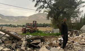 A Palestinian man stands amidst rubble following the demolition of his home in Al Jiftlik-Abu al 'Ajaj, Jericho governorate, due to lack of building permits.