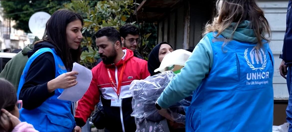 UNHCR staff distribute emergency relief items to displaced people in Beirut, Lebanon, as families gather to receive support kits following recent displacement.