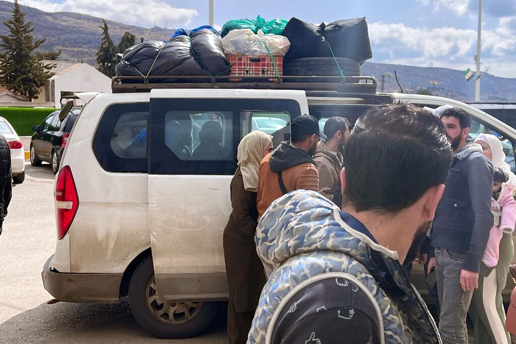 Des réfugiés arrivant au poste frontalier de Jdaidet Yabous depuis le Liban, transportant des effets personnels dans une camionnette.