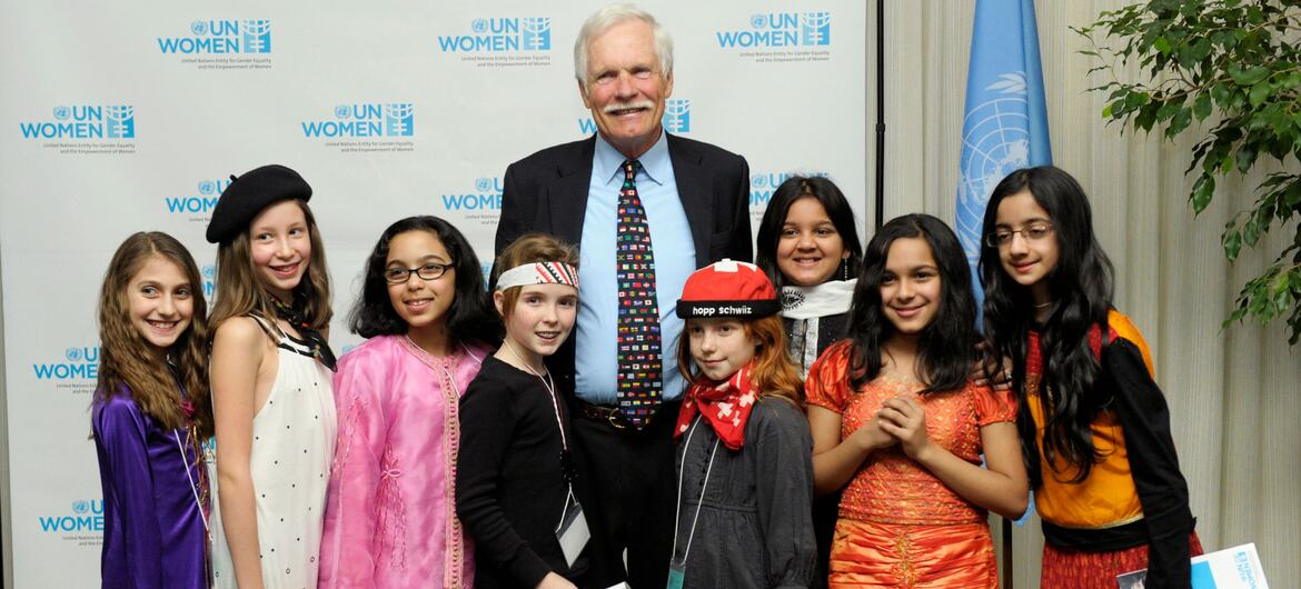 Ted Turner poses for a photo with a group of young girls at the UN Women launch event.