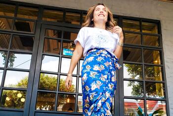 Lina Garces, a fashion expert and peace agreement survivor, smiles while modeling colorful floral skirts from the Ixora brand she co-created with other women.