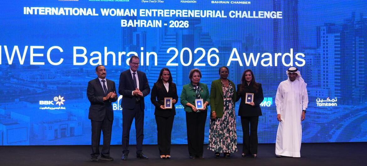 Awards ceremony for the International Woman Entrepreneurial Challenge Bahrain 2026, featuring awardees holding framed certificates on stage.