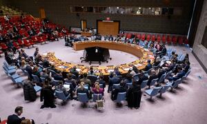A wide shot of the United Nations Security Council chamber during a meeting on Kosovo and the UN Interim Administration Mission in Kosovo (UNMIK). Delegates are seated around the iconic horseshoe table.