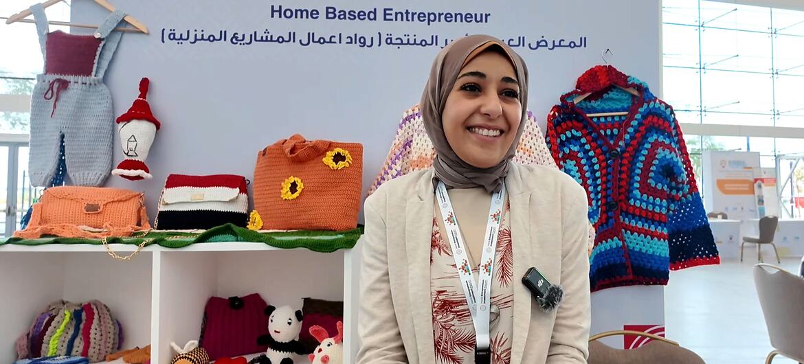 Shaymaa Saeed, a young Egyptian woman with a disability and crochet designer, smiles while showcasing her handcrafted items at the WEIF2026 event in Bahrain.