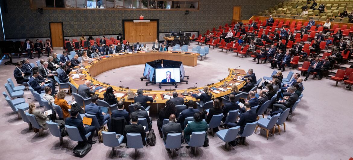 A wide view of the UN Security Council meeting focused on the maintenance of peace and security in Ukraine, with delegates seated around a large circular table.