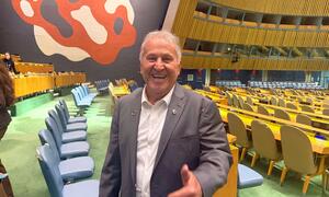 Brazilian football legend Zico smiles and gives a thumbs up inside the UN General Assembly hall. Melissa Fleming, Under-Secretary-General for Global Communications, is also present.