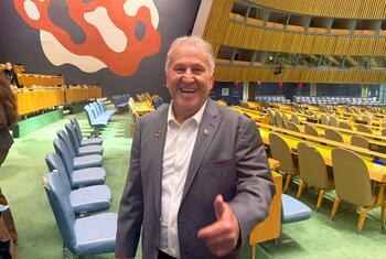 Brazilian football legend Zico smiles and gives a thumbs up inside the UN General Assembly hall. Melissa Fleming, Under-Secretary-General for Global Communications, is also present.
