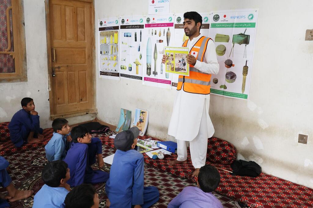 Demining Agency for Afghanistan (DAFA) Explosive Ordnance Risk Education trainer equips children with life-saving knowledge on explosive risks, Kunar Province, Afghanistan. 