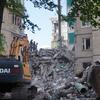 Rescue workers and an excavator at a damaged residential building in Kyiv following a Russian missile and drone attack.