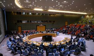 Wide view of the UN Security Council meeting discussing the situation in Iran, with delegates seated around a large circular table.