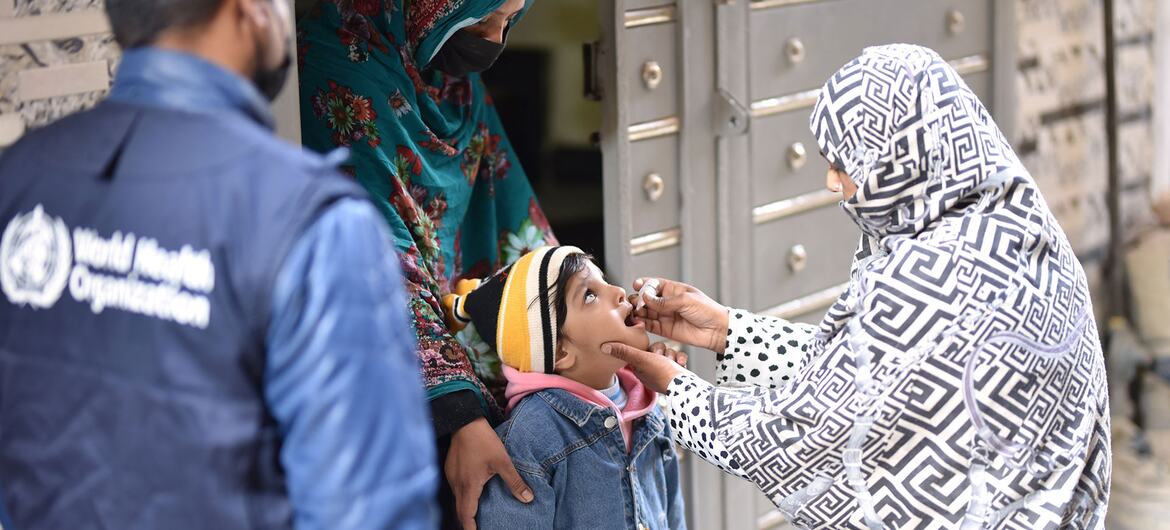 A WHO-trained polio worker administers a vaccine to a child in Pakistan during a national polio vaccination campaign in February 2026.
