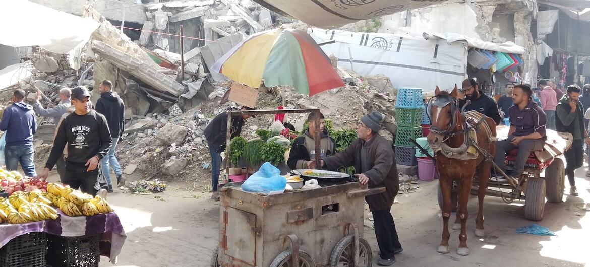 Vendedores ambulantes operam em meio a edifícios destruídos em Gaza durante o Ramadã, mostrando resiliência em um ambiente devastado pela guerra.