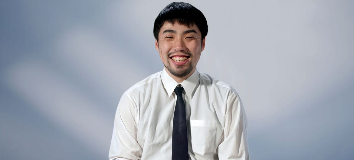 Masaki Umeda, co-founder of SORA Technology, smiles at the camera wearing a white shirt and dark tie.